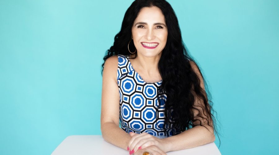 Dr Josephine Palermo portrait against turquoise background