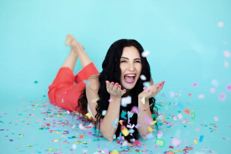 photo of woman blowing confetti