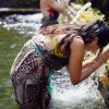 woman receiving a water temple blessing in Bali