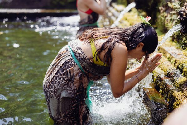 woman receiving a water temple blessing in Bali